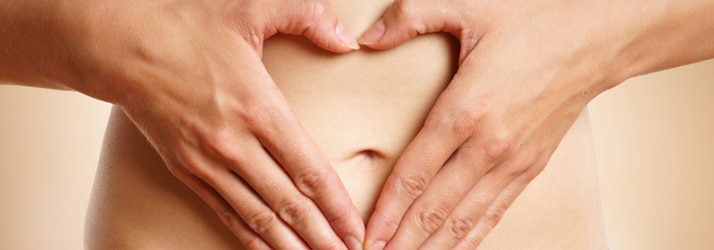 woman placing hands on her tummy