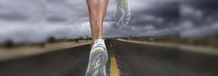 athlete Running down road in storm